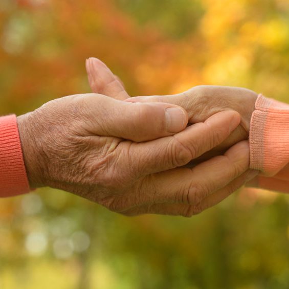 Elderly couple holding hands