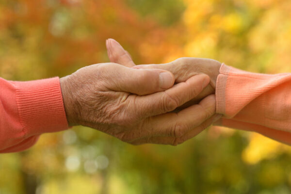 Elderly couple holding hands